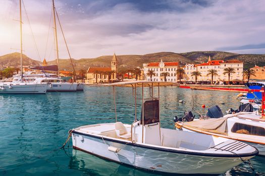 Trogir boats and waterfront view, UNESCO town in Croatia landmarks. View of historic buildings and port with boats in Trogir town, Dalmatia, Croatia.