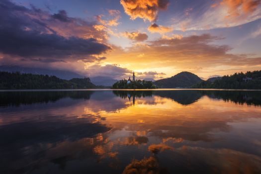 Lake Bled Slovenia. Beautiful sunrise over Bled lake with small Pilgrimage Church. Most famous Slovenian lake and island Bled with Pilgrimage Church of the Assumption of Maria. Bled, Slovenia.