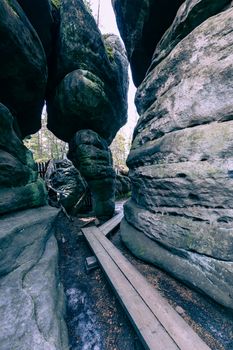 Stolowe Mountains National Park. Path in Rock Labyrinth hiking trail Bledne Skaly. Errant Rocks in Sudetes Mountains near Kudowa-Zdroj, Lower Silesia, Poland.