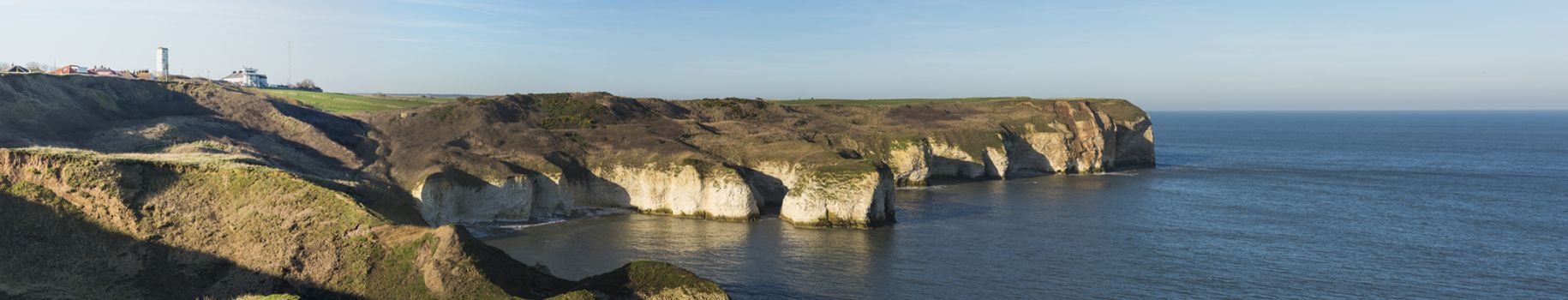 Landscape coastal scene of large chalks cliffs coastline dropping into sea