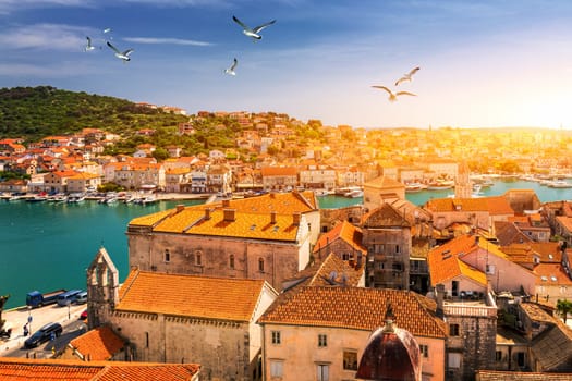 View at town Trogir, old touristic place in Croatia Europe with seagull's flying over city. Trogir town coastal view. Magnificent Trogir, Croatia. Sunny old Venetian town, Dalmatian Coast in Croatia.