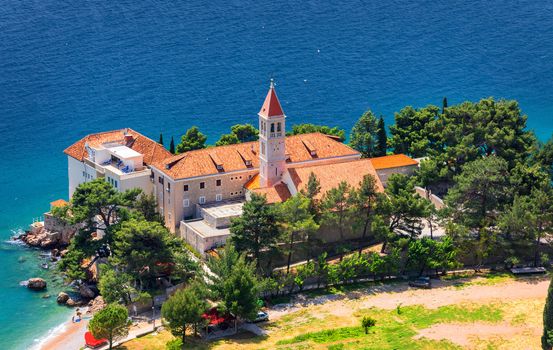 View of beautiful bay with beach and Dominican monastery in Bol town, Brac island, Croatia. Dominican monastery in Bol, built in 15th century. Bol town, Brac island, Croatia.