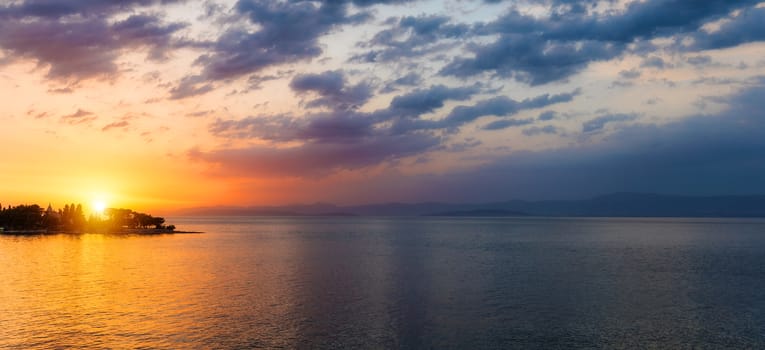 Sunset or sunrise sky above the sea. Nature, weather, atmosphere, travel theme. Sunrise or sunset over the sea. Panorama