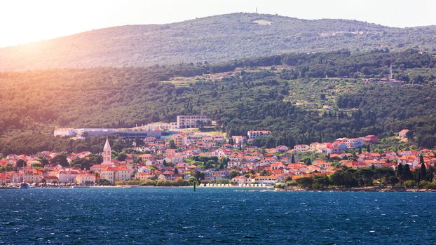Supetar city in Brac island, Croatia. View from the sea. Picturesque scenic view on Supetar on Brac island, Croatia. Panoramic view on harbor of town Supetar from the side of sea. Brac, Croatia.