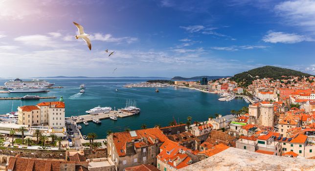 Split waterfront and Marjan hill aerial view, Dalmatia, Croatia. Panoramic summer cityscape of old medieval city Split, Croatia, Europe.  Traveling concept background. Seagull's flying over Split.