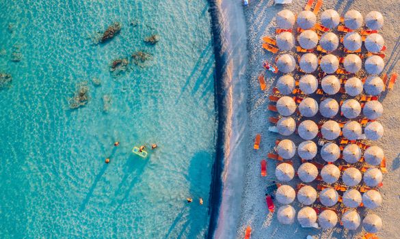 Aerial view of beautiful tropical Elafonissi Beach with pink sand. View of a nice tropical beach from the air. Beautiful sky, sea, resort. Seascape: Ocean and beautiful beach paradise. Elafonissi beach, Crete, Greece.