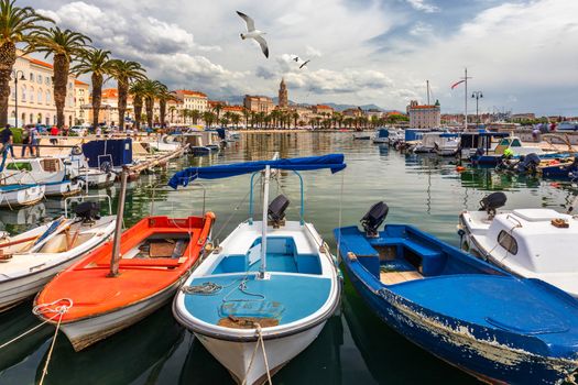 City of Split with colorful fishing boats in harbor, Dalmatia, Croatia. Waterfront view of fishing boats at mediterranean scenery in old roman town Split, Croatia. 
