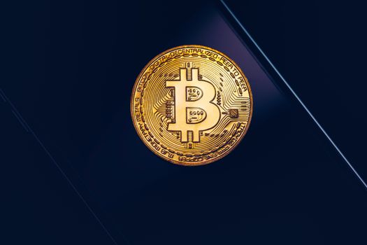 Bitcoin symbol over mobile screen, minimalist approach. Bitcoin on stock market. New digital money. Golden Bitcoin over smartphone display.