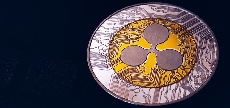 Ripple cryptocurrency (crypto currency). Silver Ripple coin with gold Ripple symbol. Ripple (XRP) cryptocurrency.