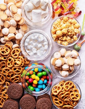 Sweet food. Topview of various sweets in bowls and scattered over the table. Sweets background