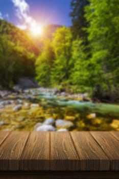Empty wooden table in front of abstract blurred background in nature, can be used for display or montage your products. Mock up for display of product