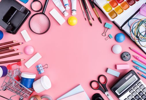 Back to school concept. School and office supplies on pink table. Flat lay with copy space.