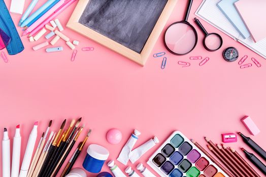 Back to school concept. School and office supplies on pink table. Flat lay with copy space double border