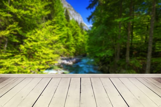 Empty wooden table in front of abstract blurred background in nature, can be used for display or montage your products. Mock up for display of product