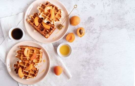 belgian waffles with fresh apricots and honey on white background top view flat lay with copy space