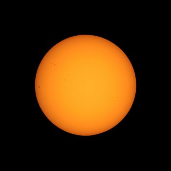 the Sun seen with telescope from planet Earth, with sunspots visible as dark spots compared to surrounding regions