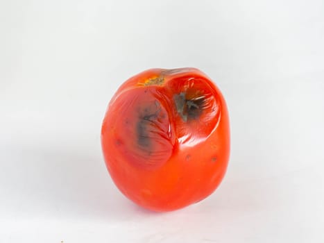 Rotten Tomatoes,Is a red fruit
Sour and sweet,Skin has black mold,
White background