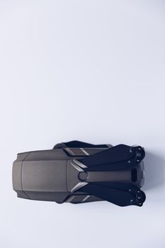 New modern drone on display on white background. Drone quadcopter with digital camera.