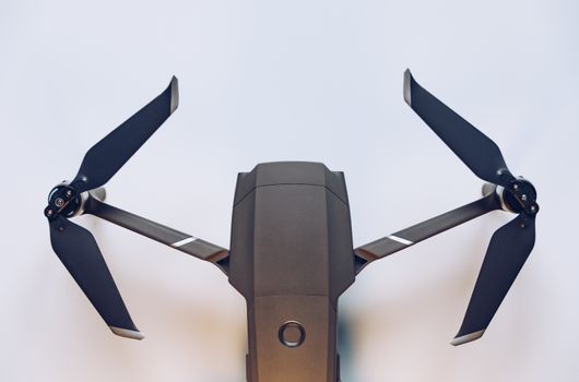 New modern drone on display on white background. Drone quadcopter with digital camera.