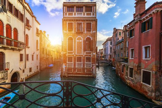 Street canal in Venice, Italy. Narrow canal among old colorful brick houses in Venice, Italy. Venice postcard