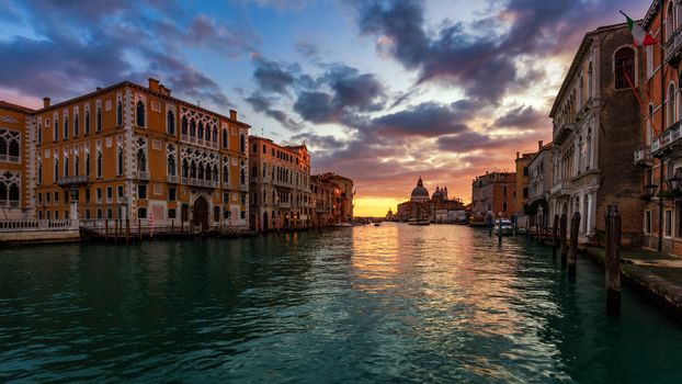 View of the street canal in Venice, Italy. Colorful facades of old Venice houses. Venice is a popular tourist destination of Europe. Venice, Italy.