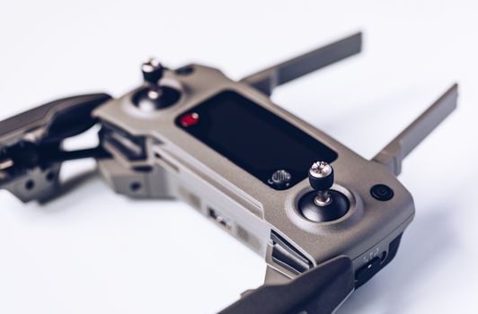 New modern drone on display on white background. Drone quadcopter with digital camera.