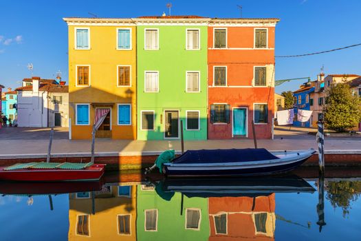Lovely house facade and colorful walls in Burano, Venice. Burano island canal, colorful houses and boats, Venice landmark, Italy. Europe