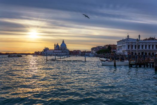 View of the street canal in Venice, Italy. Colorful facades of old Venice houses. Venice is a popular tourist destination of Europe. Venice, Italy.