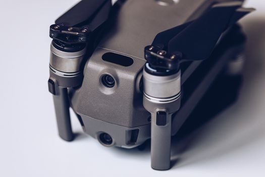 New modern drone on display on white background. Drone quadcopter with digital camera.