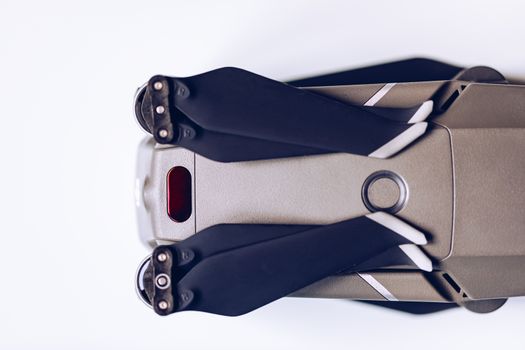 New modern drone on display on white background. Drone quadcopter with digital camera.
