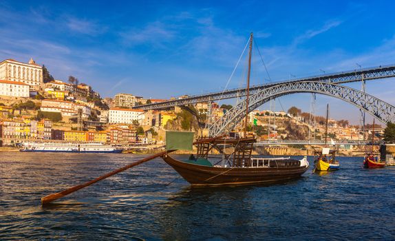 Oporto or Porto city skyline, Douro river, traditional boats and Dom Luis or Luiz iron bridge. Porto, Portugal, Europe.