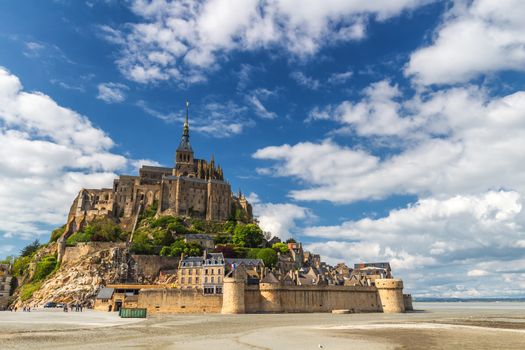Beautiful panoramic view of famous Le Mont Saint-Michel tidal island with blue sky. Normandy, northern France