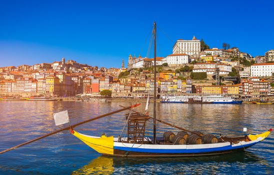 Port wine boats at the waterfront with the old town on the Douro River in Ribeira in the city centre of Porto in Porugal, Europe. Portugal, Porto