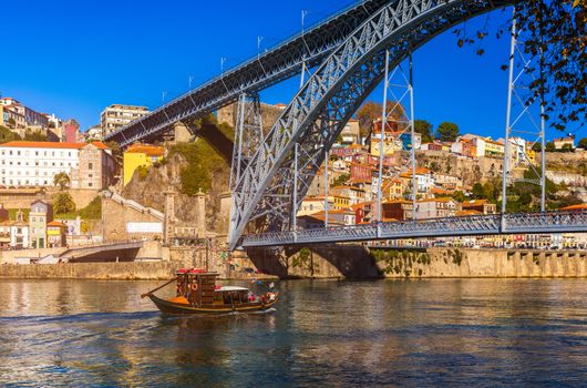 Porto panoramic aerial view of Dom Luis Bridge and houses with red roof tiles in a beautiful summer day. Porto, Portugal