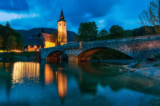 Church of Sv. John the Baptist and a bridge by the Bohinj lake in night, Slovenia. Church of St John the Baptist with bridge. Triglav National Park, Julian Alps, Slovenia, Europe