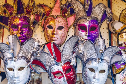 Group of Vintage venetian carnival masks. Venetian masks in store display in Venice. Annual carnival in Venice is among the most famous in Europe. Its symbol is the Venetian mask. Venice, Italy.