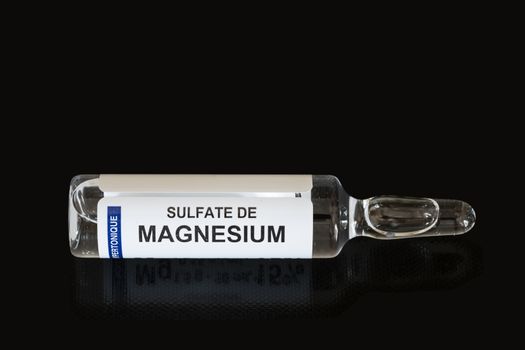 Close-up of Magnesium Sulfate glass vial for Injection or Infusion on black background