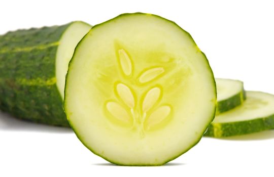 Sliced cucumber over white background.
