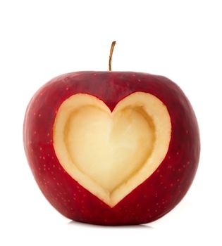 Red apple with a heart symbol isolated on white