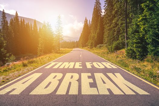 Time for a break text written on road in the mountains