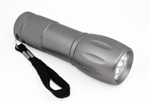 Grey pocket LED flashlight isolated on a white background. Clipping path included.