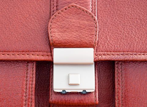 Close-up of buckle on leather business case.