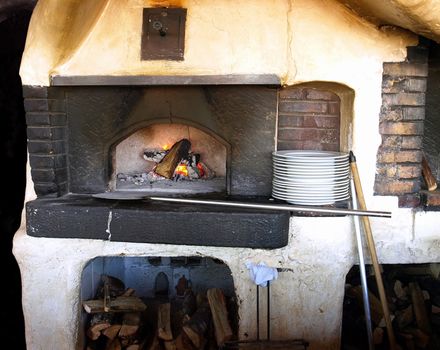 Old stove with burning firewoods.