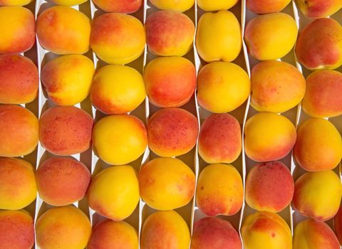 Peaches in the box in the fruits market.