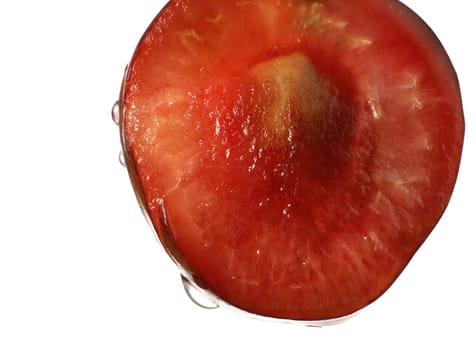 close-up of half red cherry with water drops