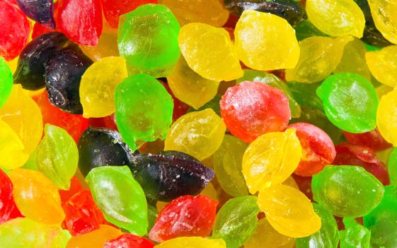 A full background of brightly colored fruit-drops candy.