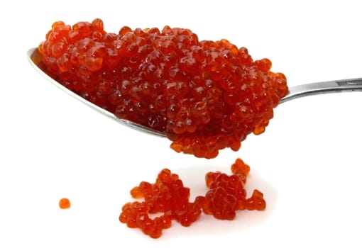 Red caviar on a spoon over white background