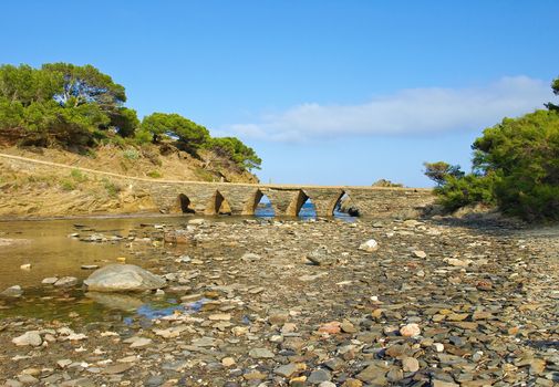 Old ancient stone bridge in Cadaques village, Costa Brava, Catalonia, Spain.