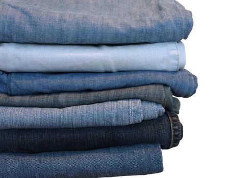 Stack of blue and black jeans over white with clipping path