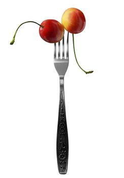 Juicy cherries on fork isolated on a white background.